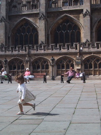 small gril in front of cathedral
