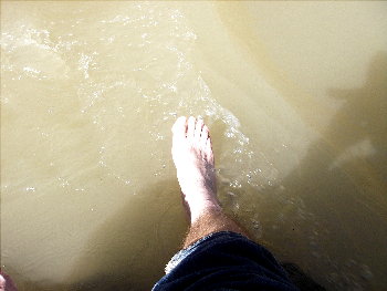 foot dabbling in water