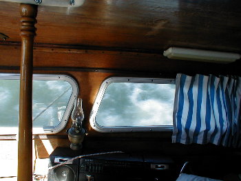 outside the cabin window of a heeled sailboat