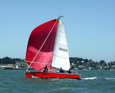 red hulled sail boat